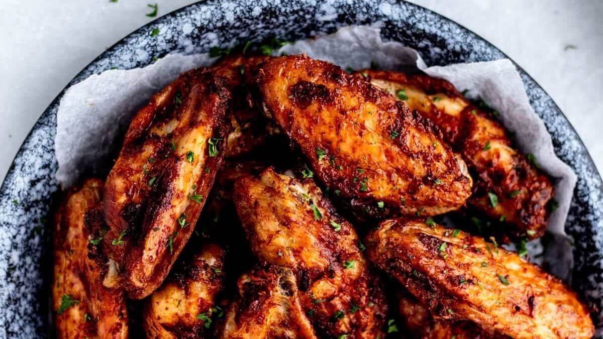 Air fryer chicken wings on a plate.
