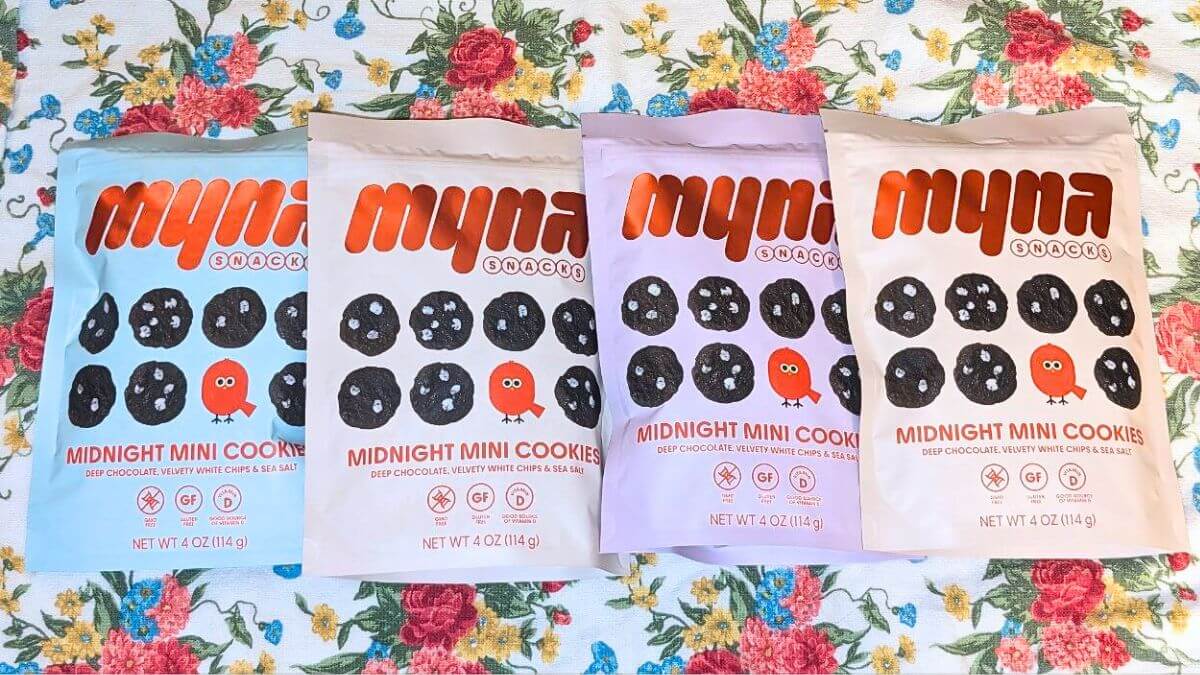 Four bags of Myna Snacks Midnight Mini Cookies on a table.