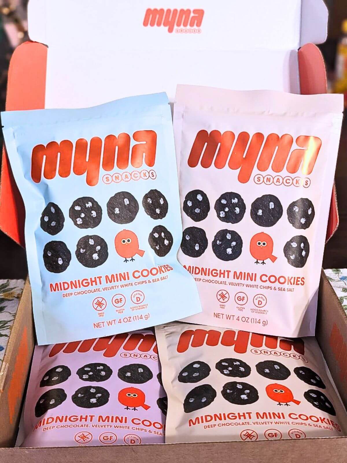 4 bags of Myna Snacks Midnight Mini Cookies in a box.