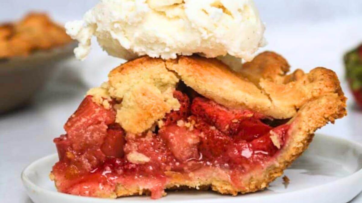 A slice of Rhubarb pie with ice cream on top.