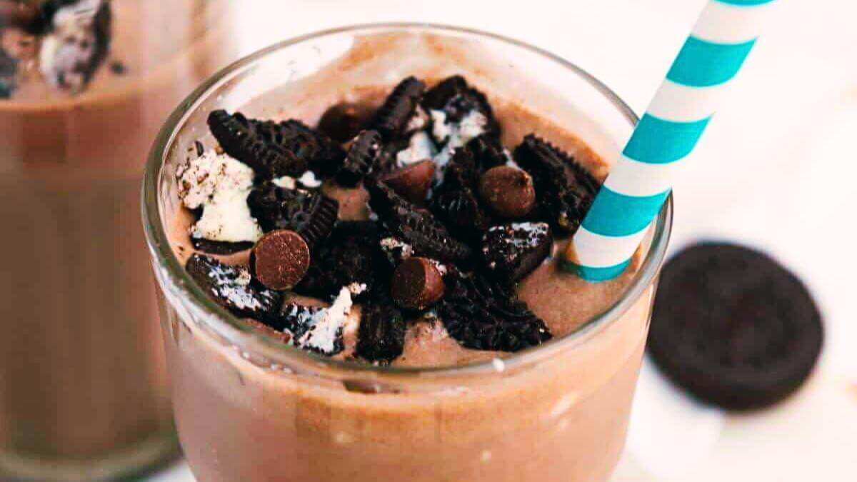 An Oreo milkshake in a glass.