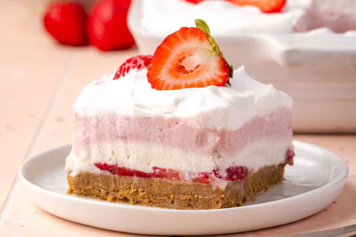 A slice of strawberry delight on a plate.