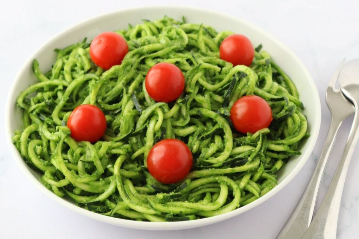 Zuccini noodles and tomatoes in a bowl.