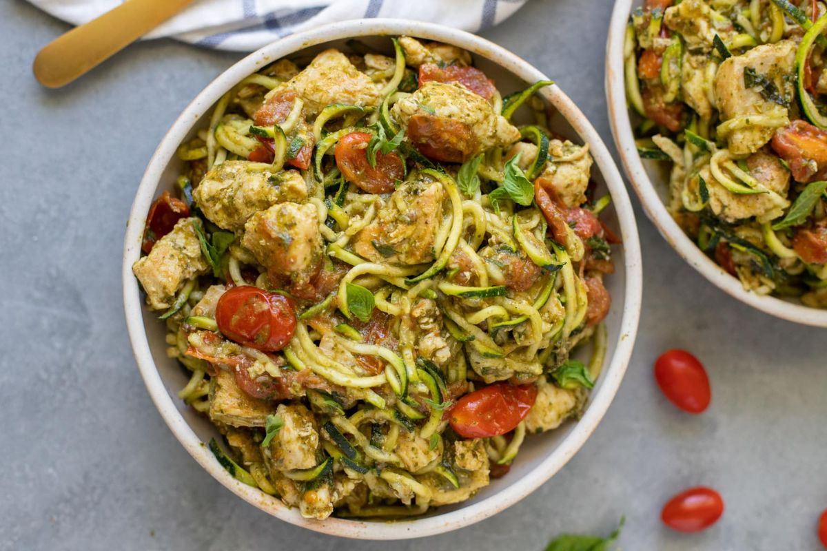 Pesto chicken with zoodles in a bowl.