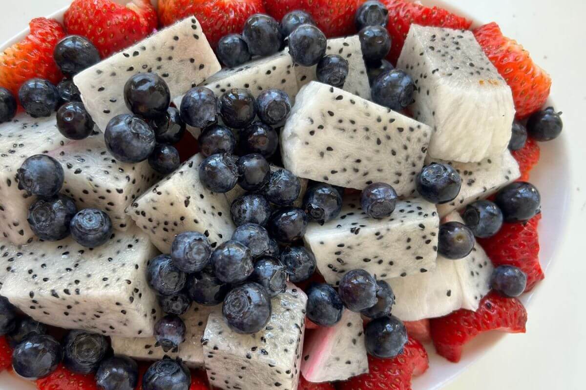 A dragon fruit salad with watermelon, strawberries, and blueberries.