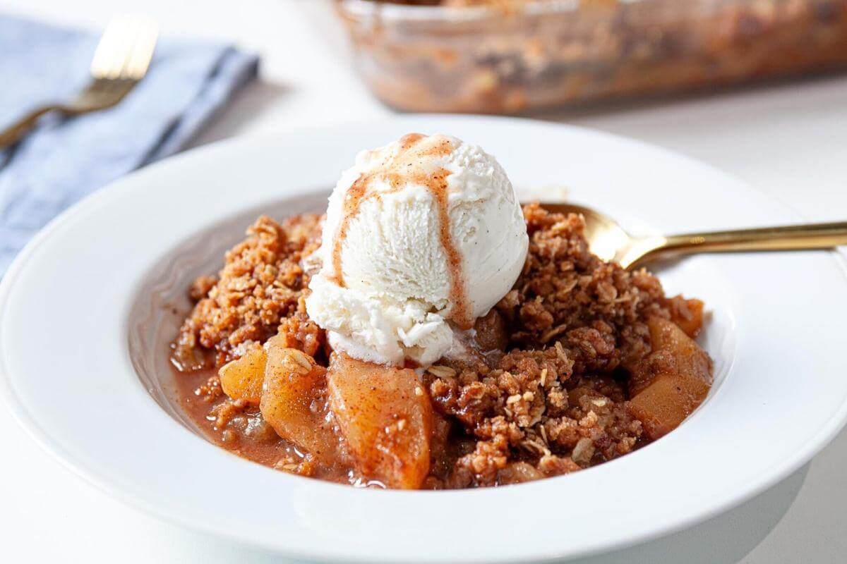 Apple crisp in a white bowl.