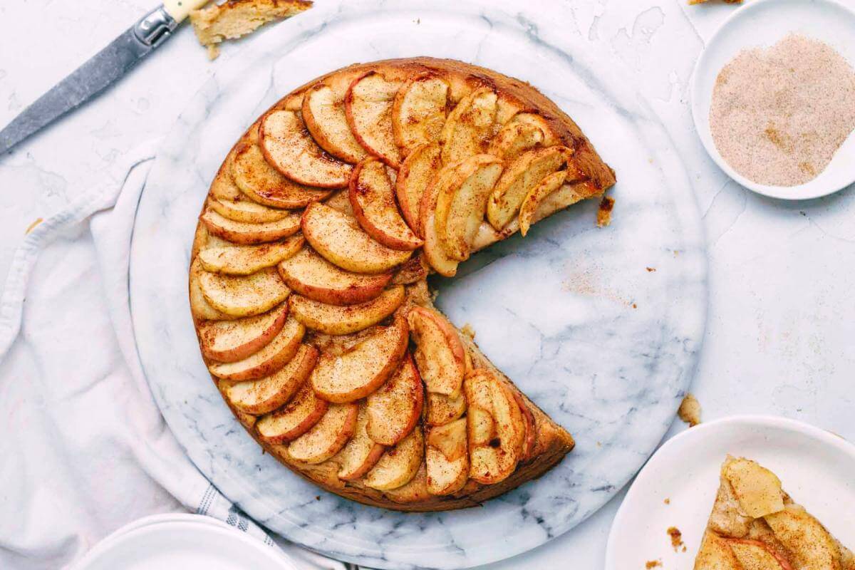 An apple cake with a slice taken out.