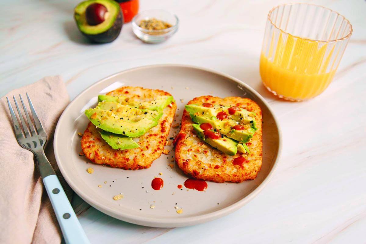 Hashbrown avocado toast on a plate.