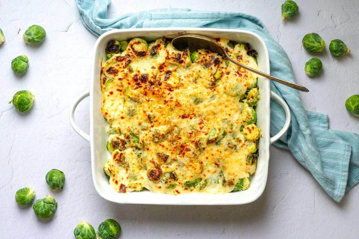 Cheesy Brussells sprouts in a baking dish.