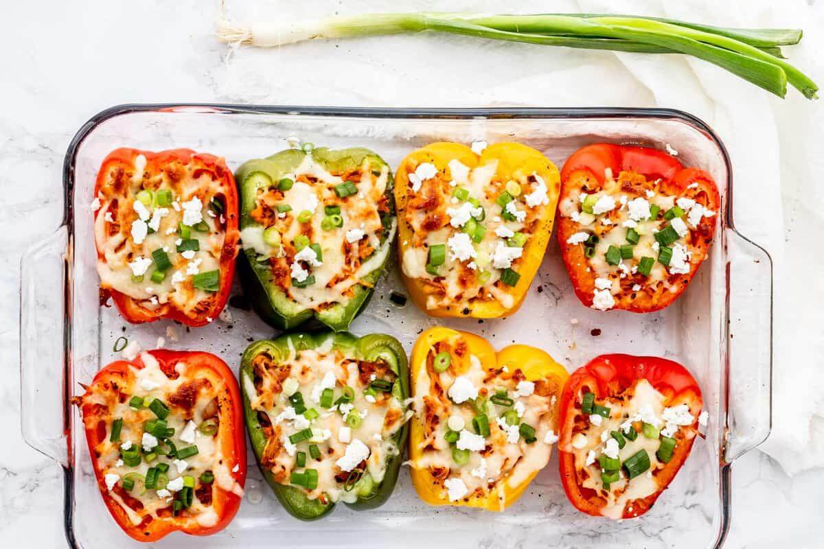 Buffalo chicken stuffed peppers in a glass dish.