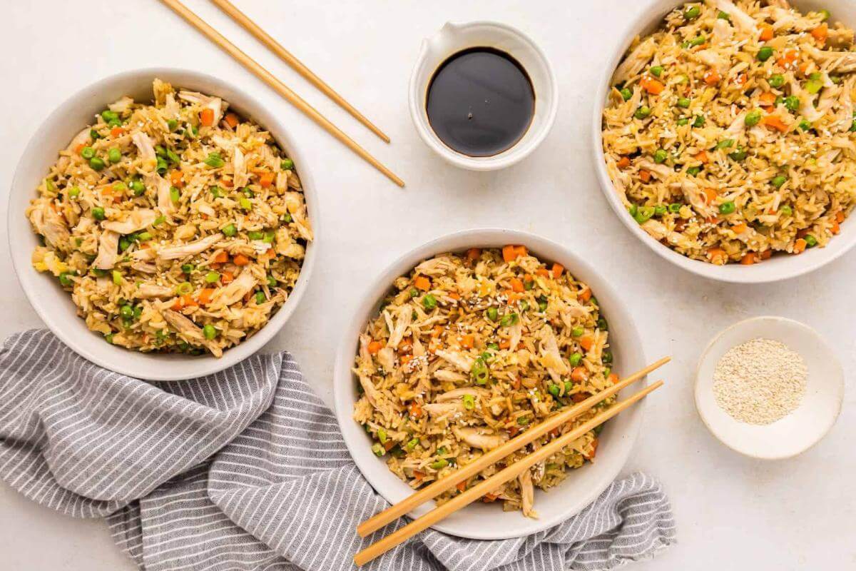 Three bowls of chicken fried rice.