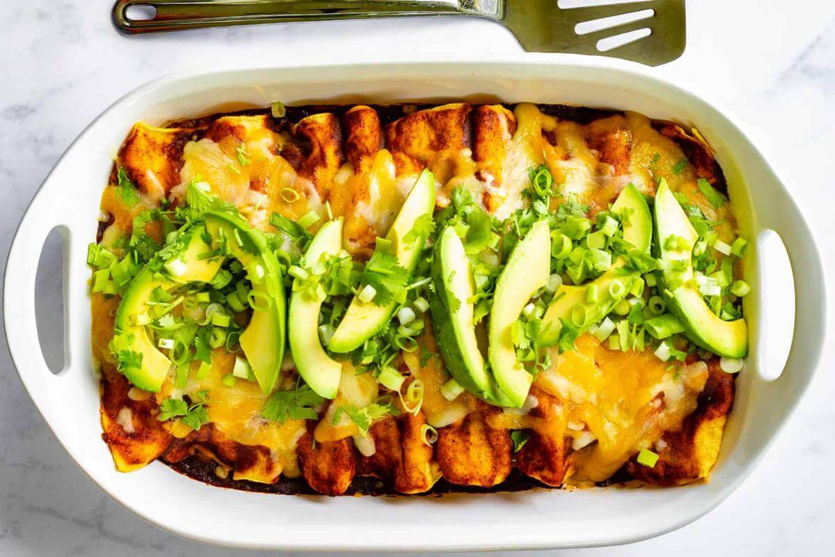 A baking dish full of enchiladas.