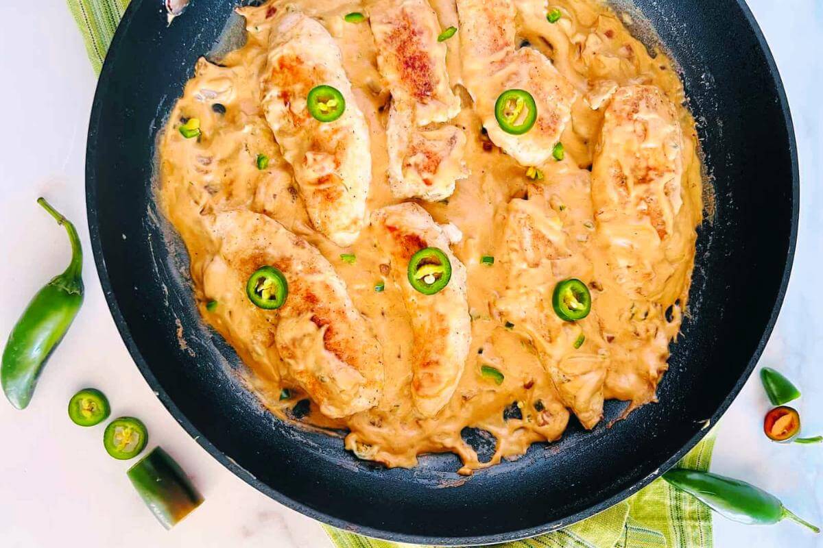 A skillet full of cheesy jalapeno chicken.