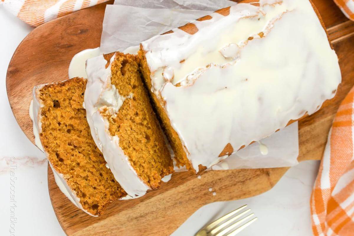 A loaf of frosted pumpkin bread.