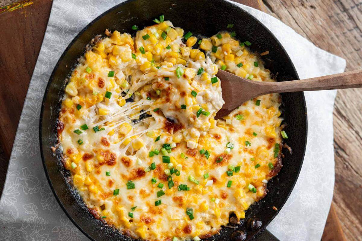 Cheesy corn in a skillet.