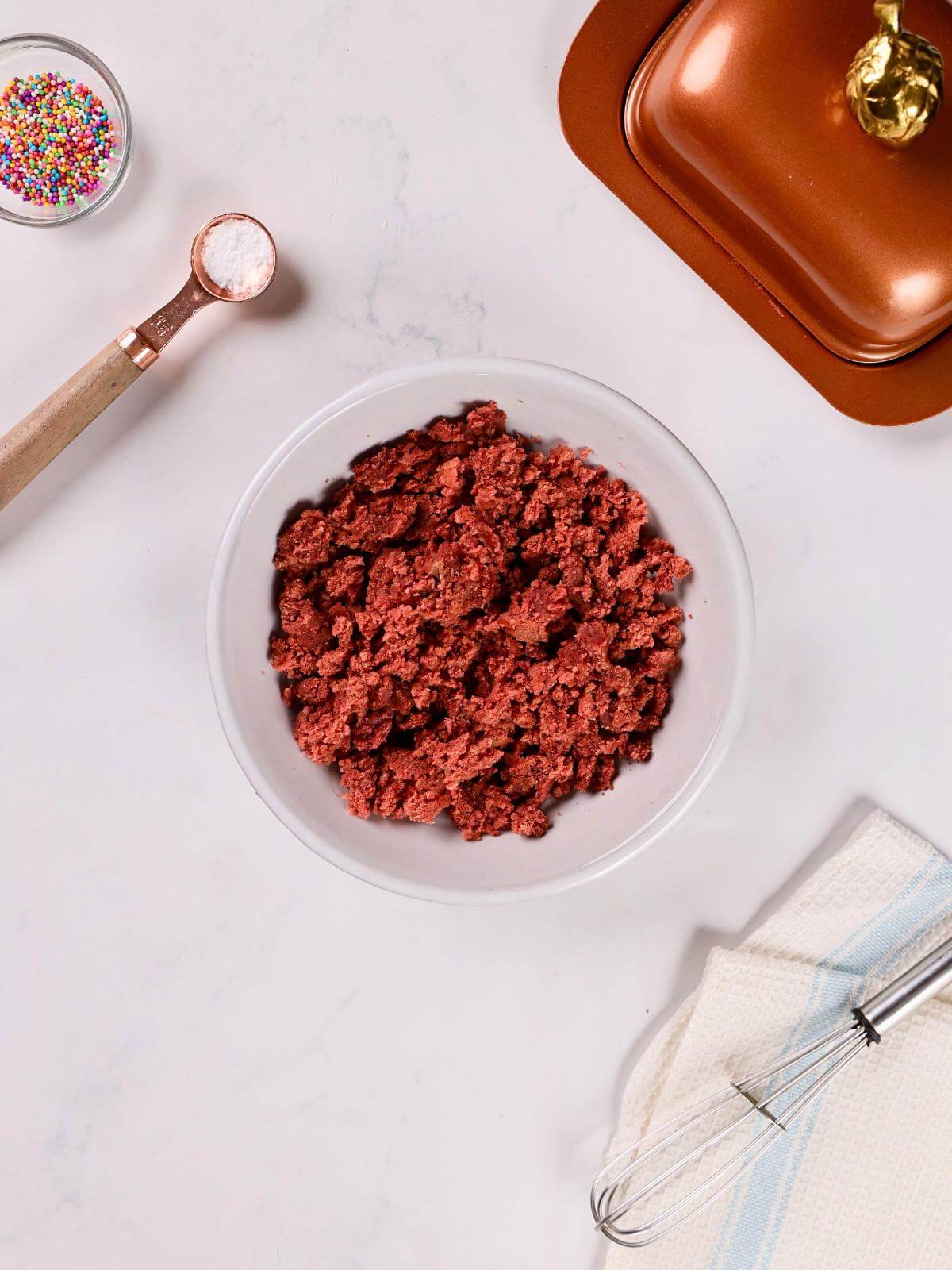 Crumbled red velvet cake in a bowl.