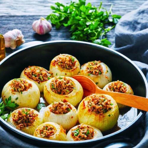 Stuffed onions in a skillet.