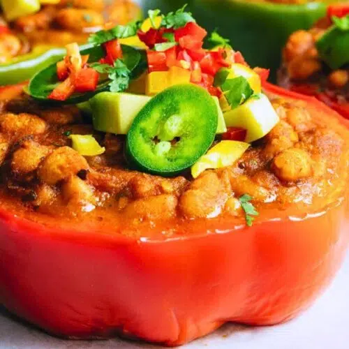 Stuffed red peppers with toppings.