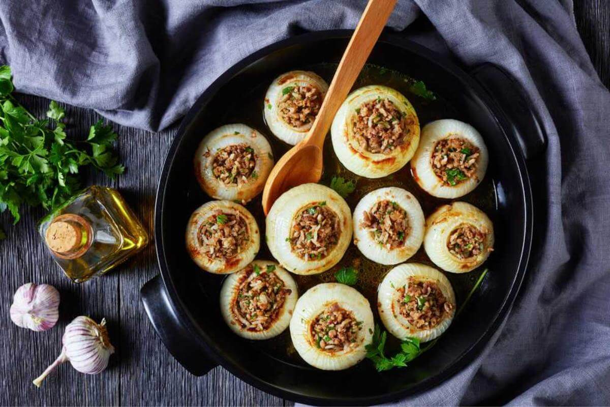 Stuffed onions in a skillet.