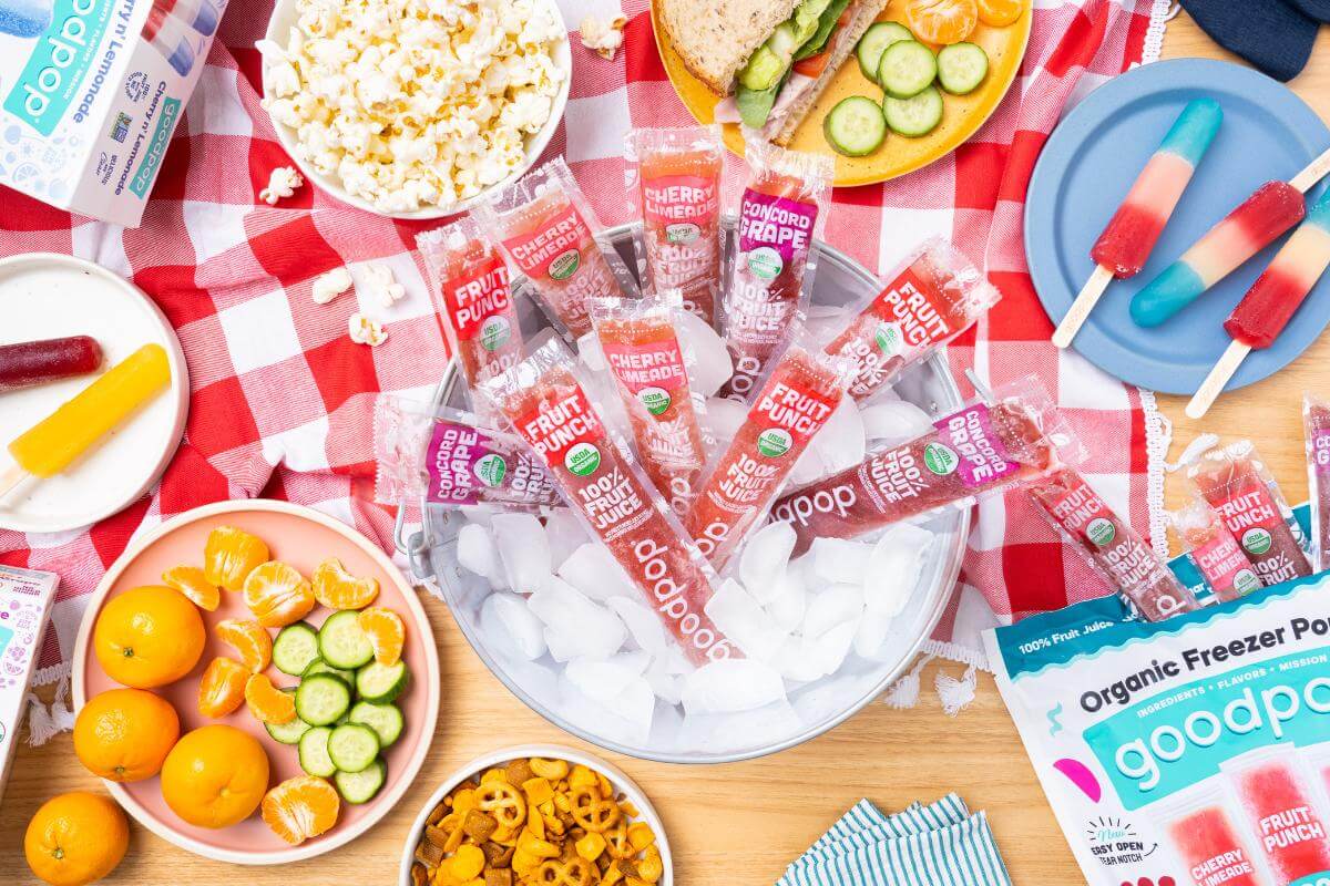 GoodPop popsicles in a bucket full of ice amongst a picnic spread.