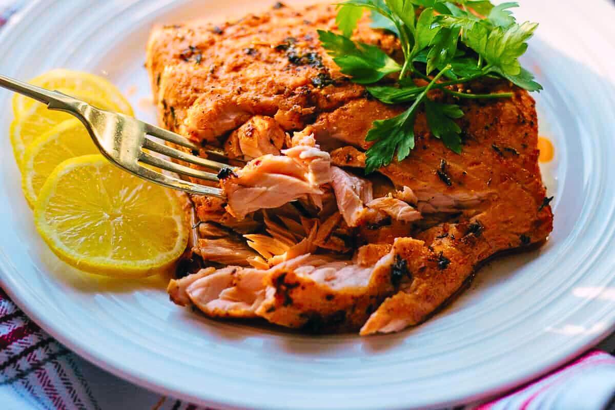 Mediterranean baked salmon on a plate.