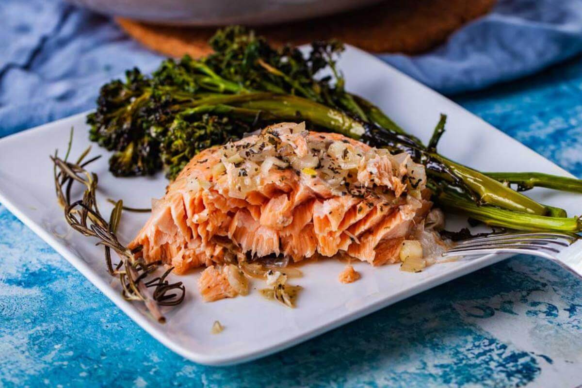 Salmon and broccolini on a plate.