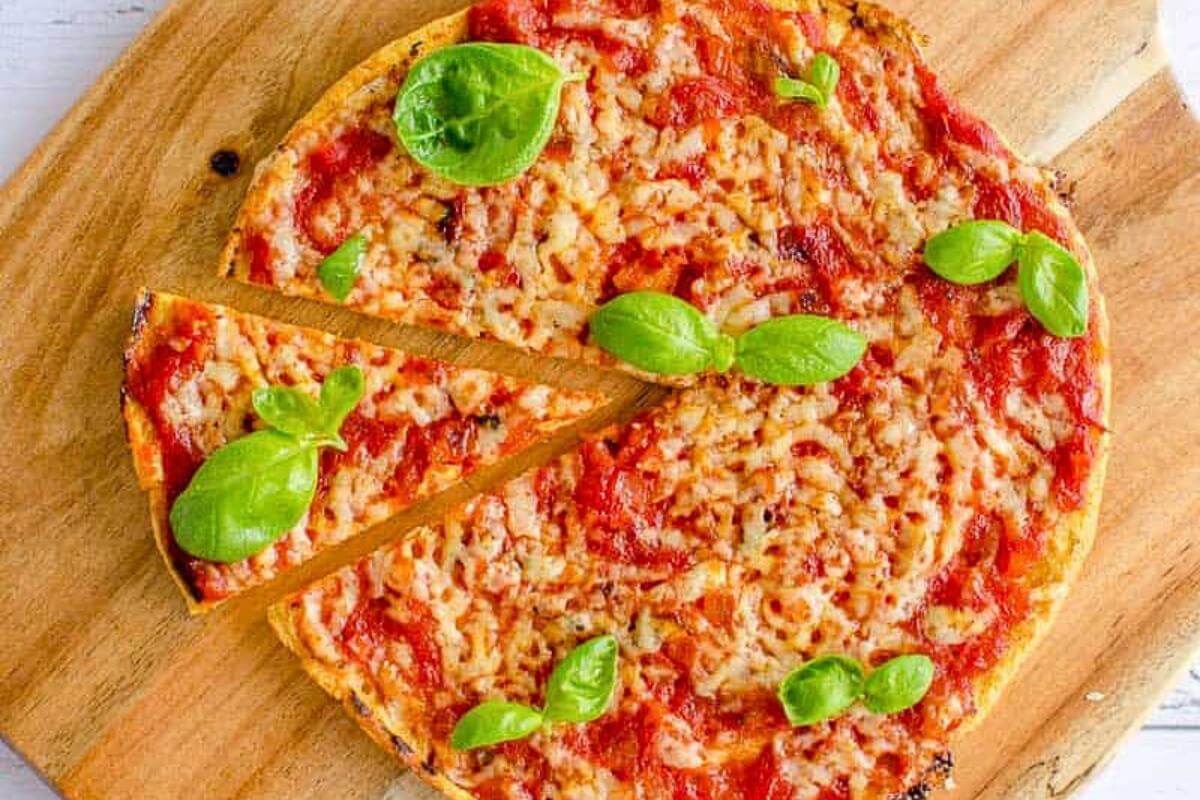 Pizza with basil on top.