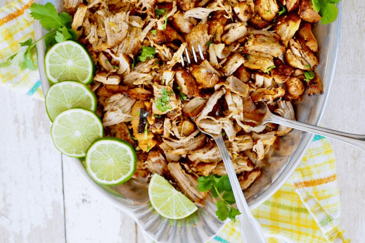 Carnitas in a dish with lime.