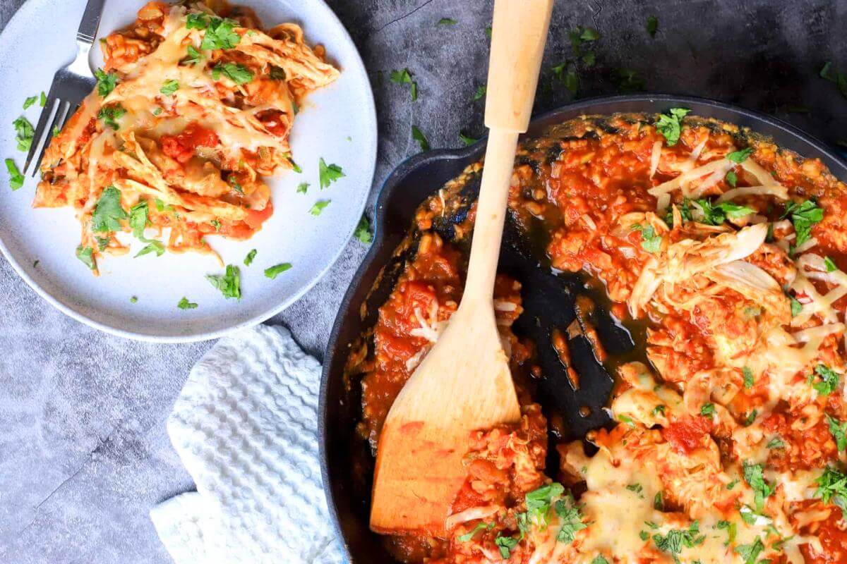 Chicken and cauliflower rice in a skillet.