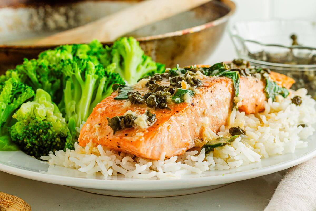 Garlic butter salmon scampi on a plate.