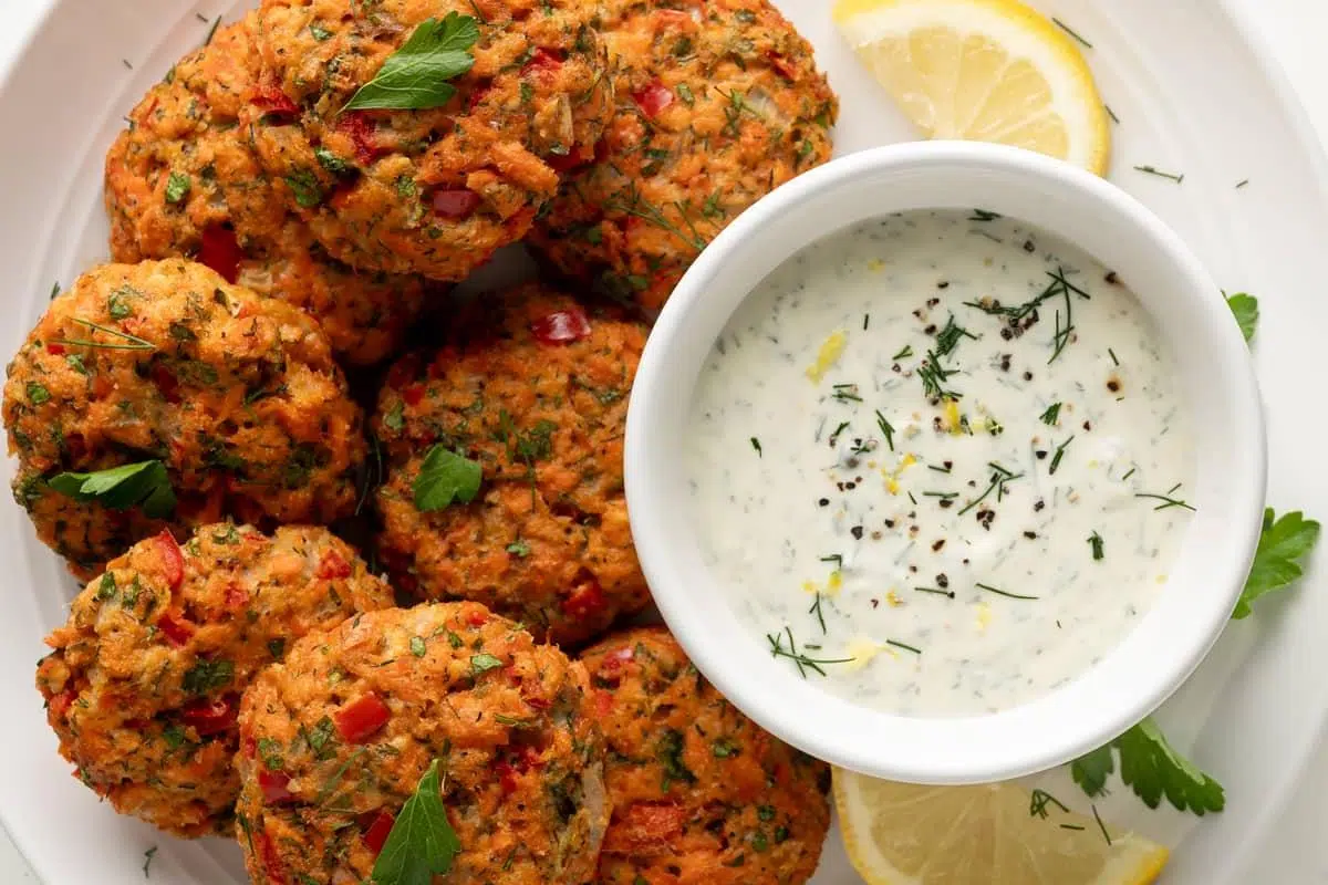 Gluten-Free Salmon Cakes topped with lemon-dill crème fraîche sauce.