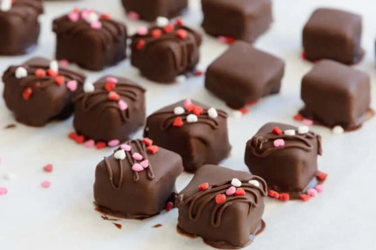 Almond Strawberry Bites Dipped in Carob or Chocolate sprinkled with heart shaped candies.