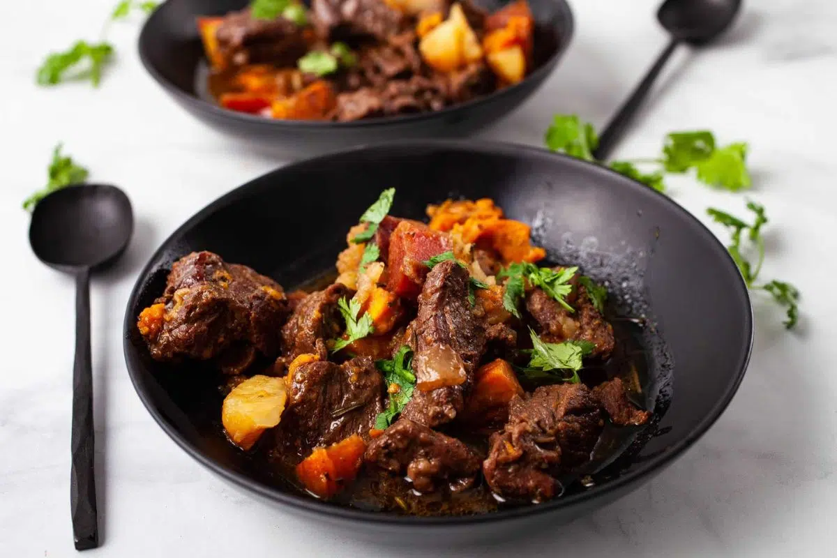 Beef stew in a skillet.