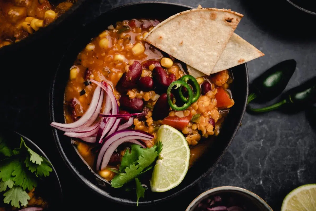 Easy Vegan Chili Recipe with pitta bread served in a bowl.