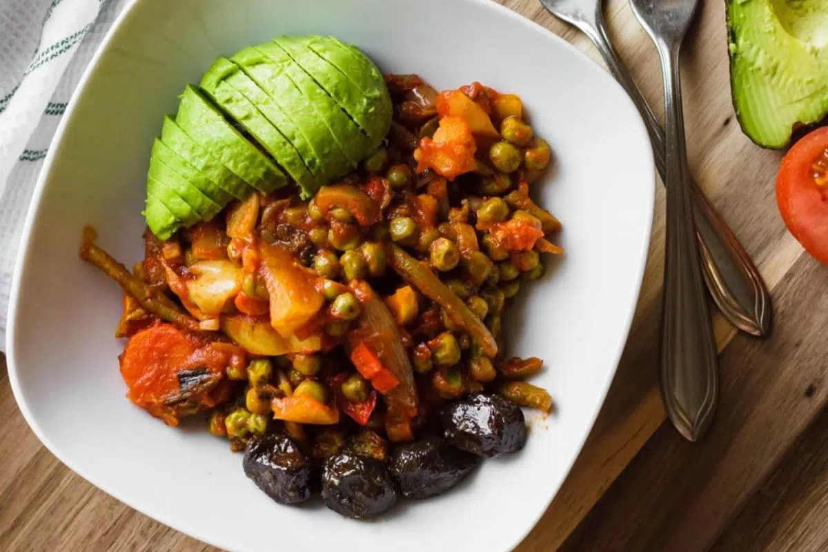 Hearty Vegetable Stew withe fresh avocado on a plate.