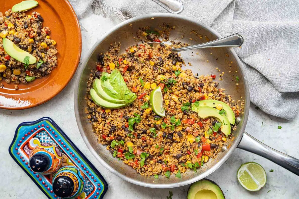 One-Pan Mexican Quinoa topped with avocado slices.
