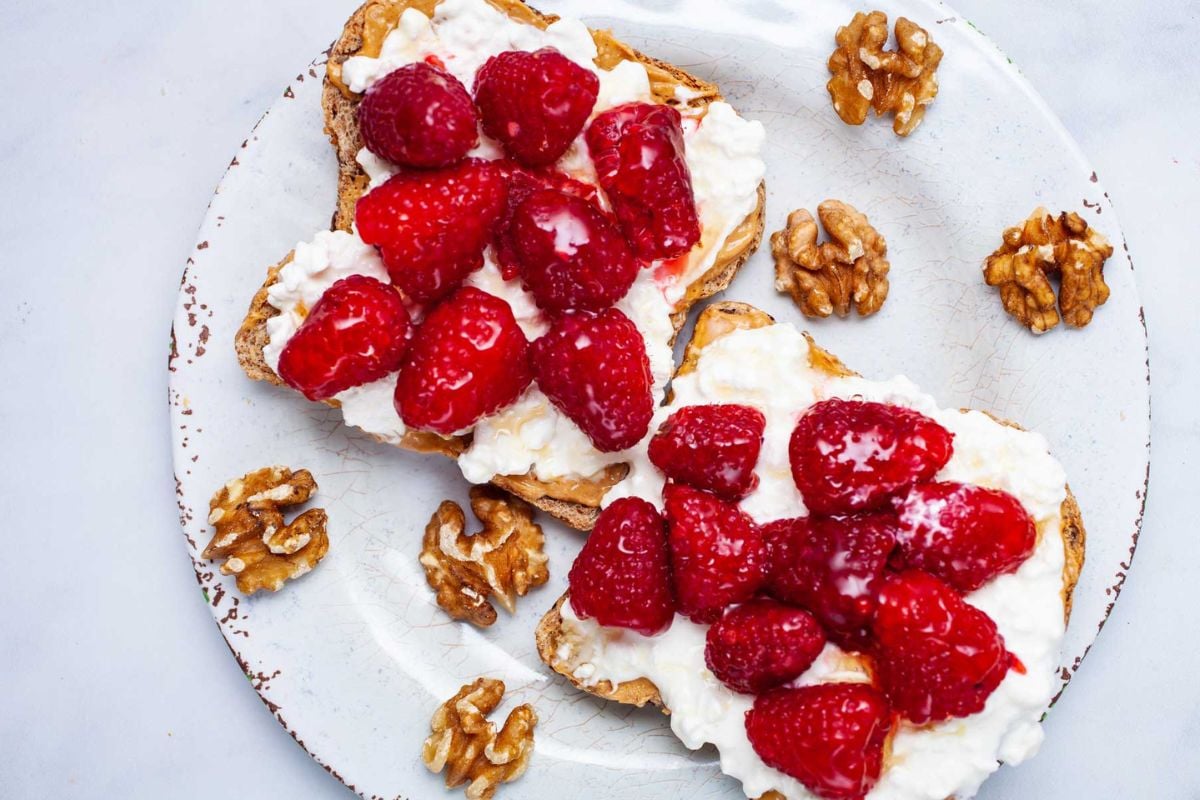 Peanut Butter Cottage Cheese Toast With Fresh Berries on a plate.