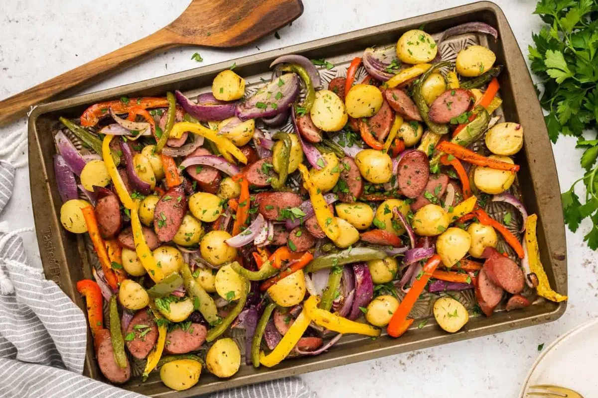Sheet Pan Sausage and Vegetables and a spatula on the side.