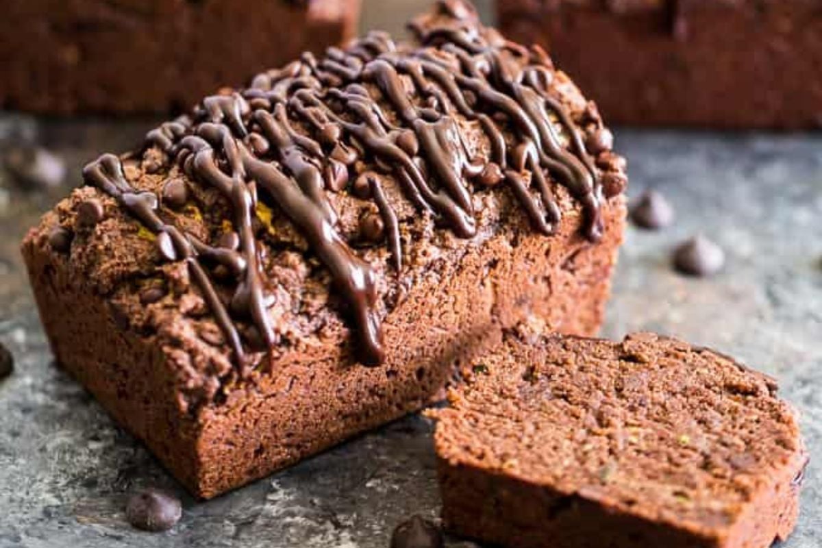 Triple Chocolate Zucchini Bread drizzled with chocolate glaze on top.