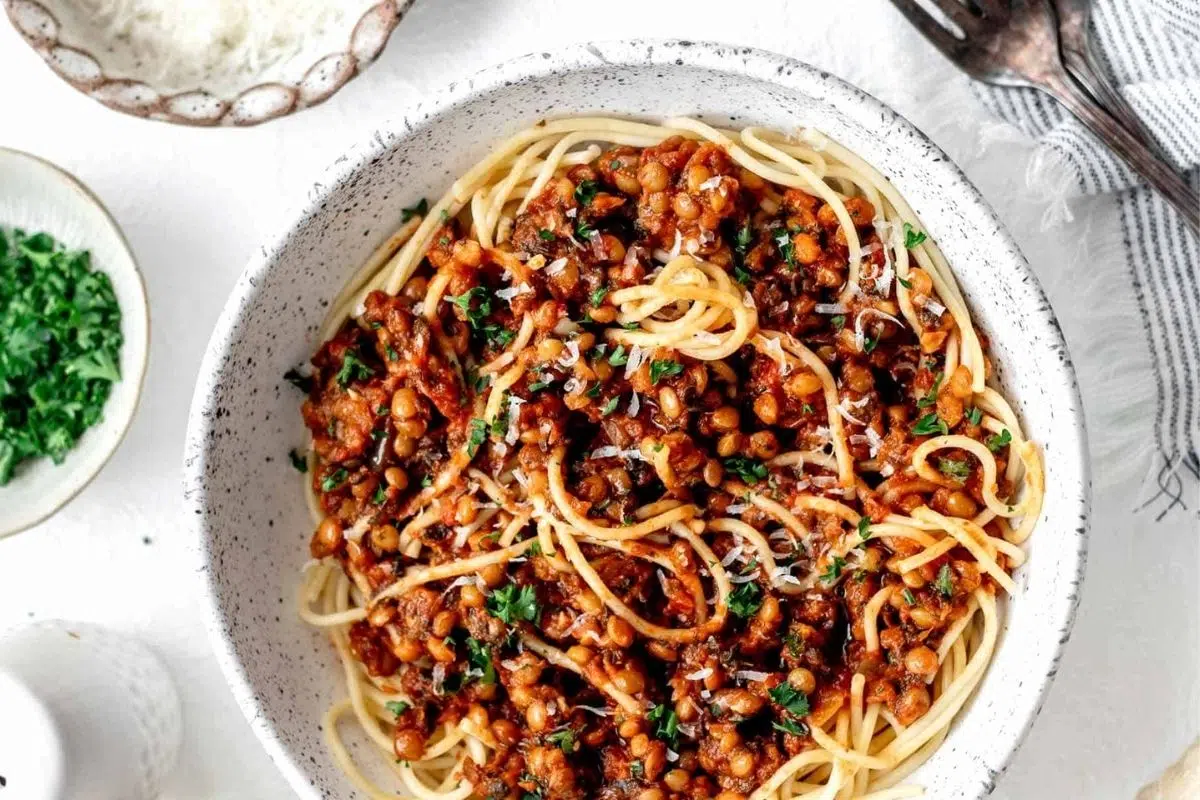 Vegan Green Lentil Bolognese topped with parsley on a plate.