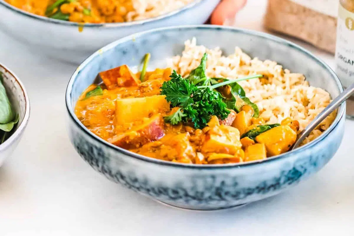 Vegan Lentil Curry with rice and topped with celery.