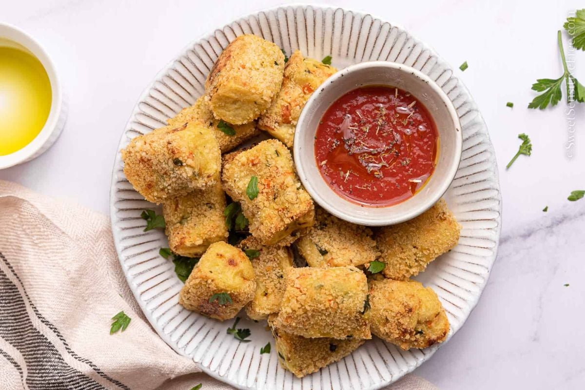 Veggie Tots served in a plate with cashew sauce.