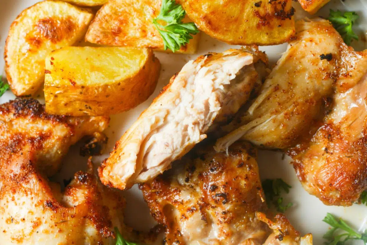 Air Fryer Chicken Thighs with fried potato slices.