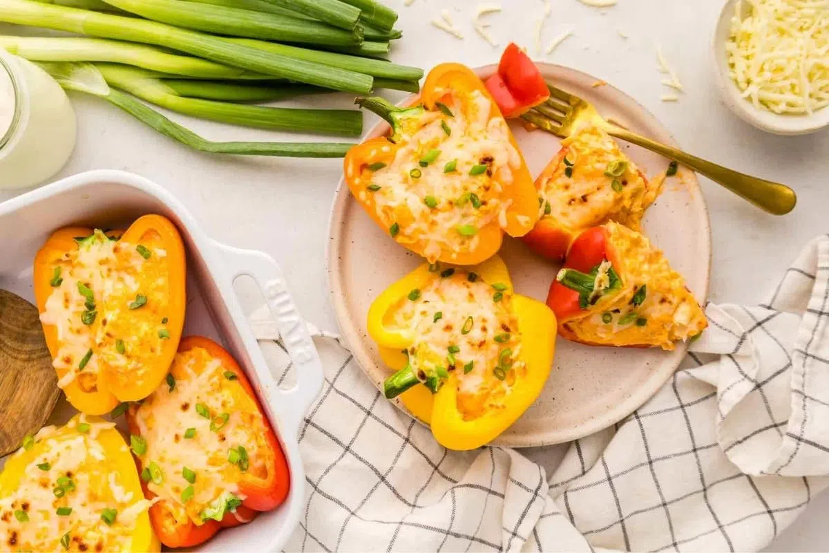 Buffalo Chicken Stuffed Peppers alongside spring onions.