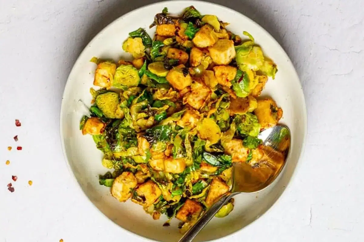 Chili Garlic Tofu with Brussels Sprouts served on a plate.