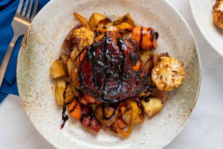 Easy Sheet Pan Balsamic Chicken Thighs with Roasted Vegetables served on a plate.