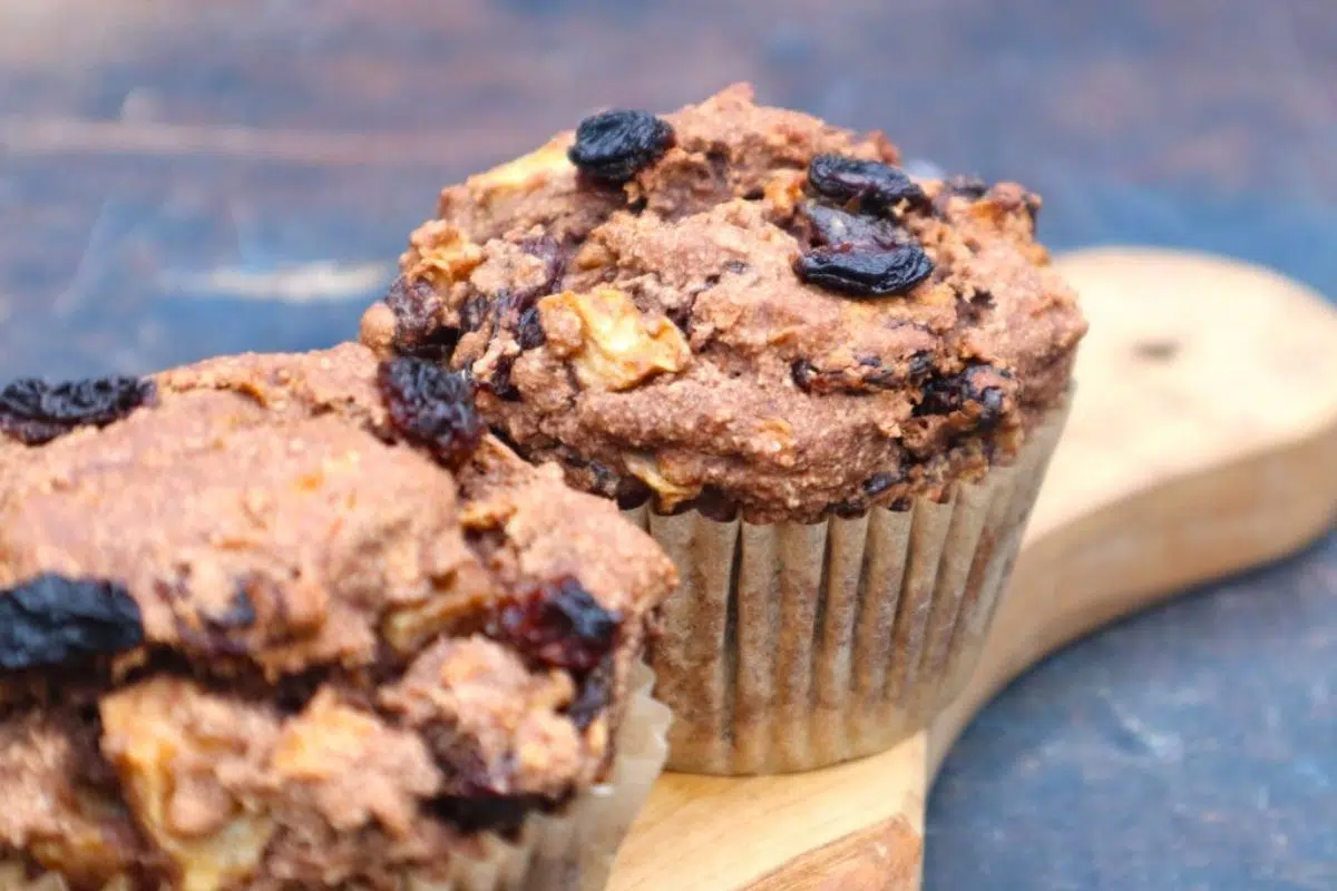 Glutenfree, fatfree and vegan apple raisin muffins on  a wooden board.