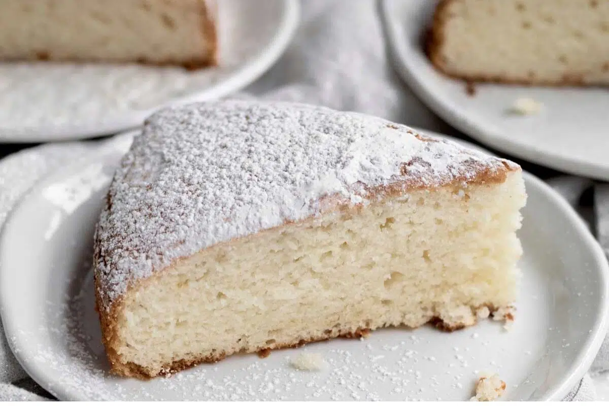 Irish Tea Cake served in a plate and topped with powdered sugar.