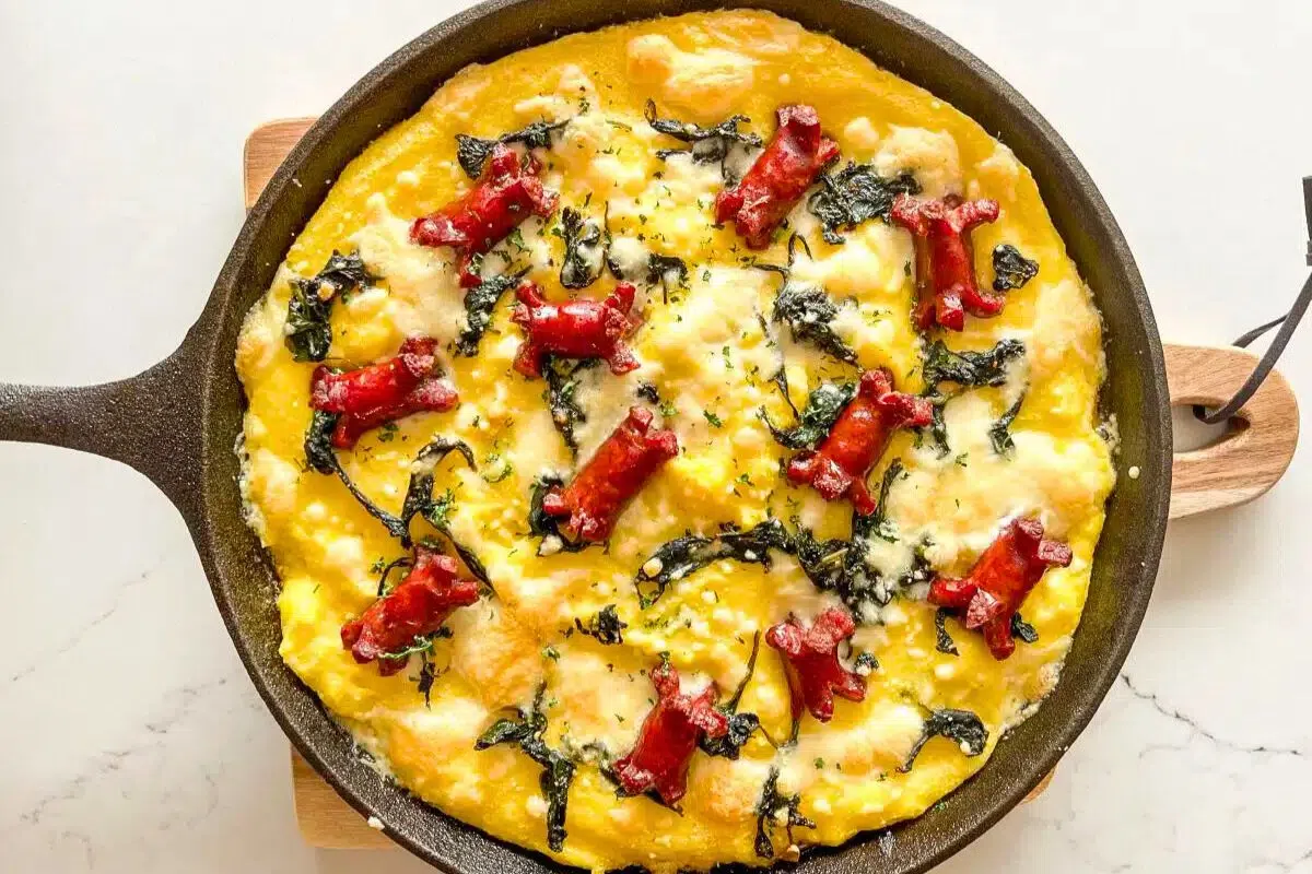 Polenta Casserole with Sausage and Spinach in a pan.