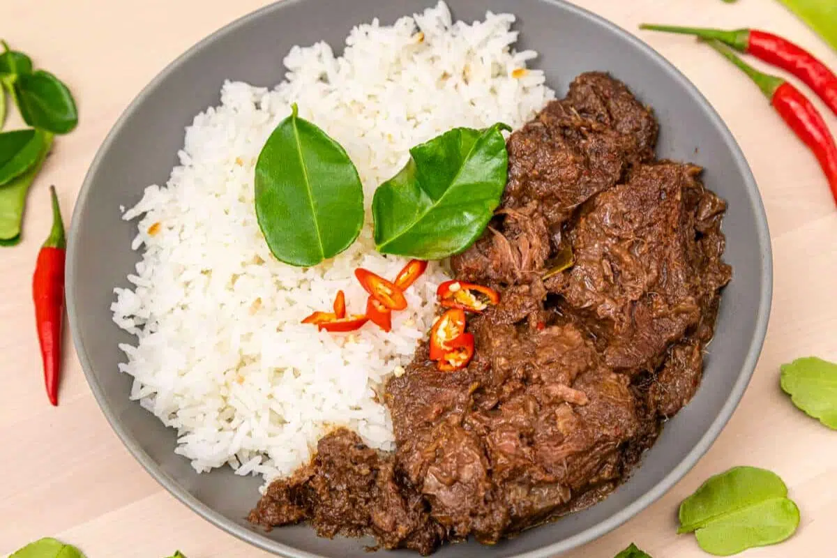 Slow Cooker Beef Rendang topped with chopped chili.